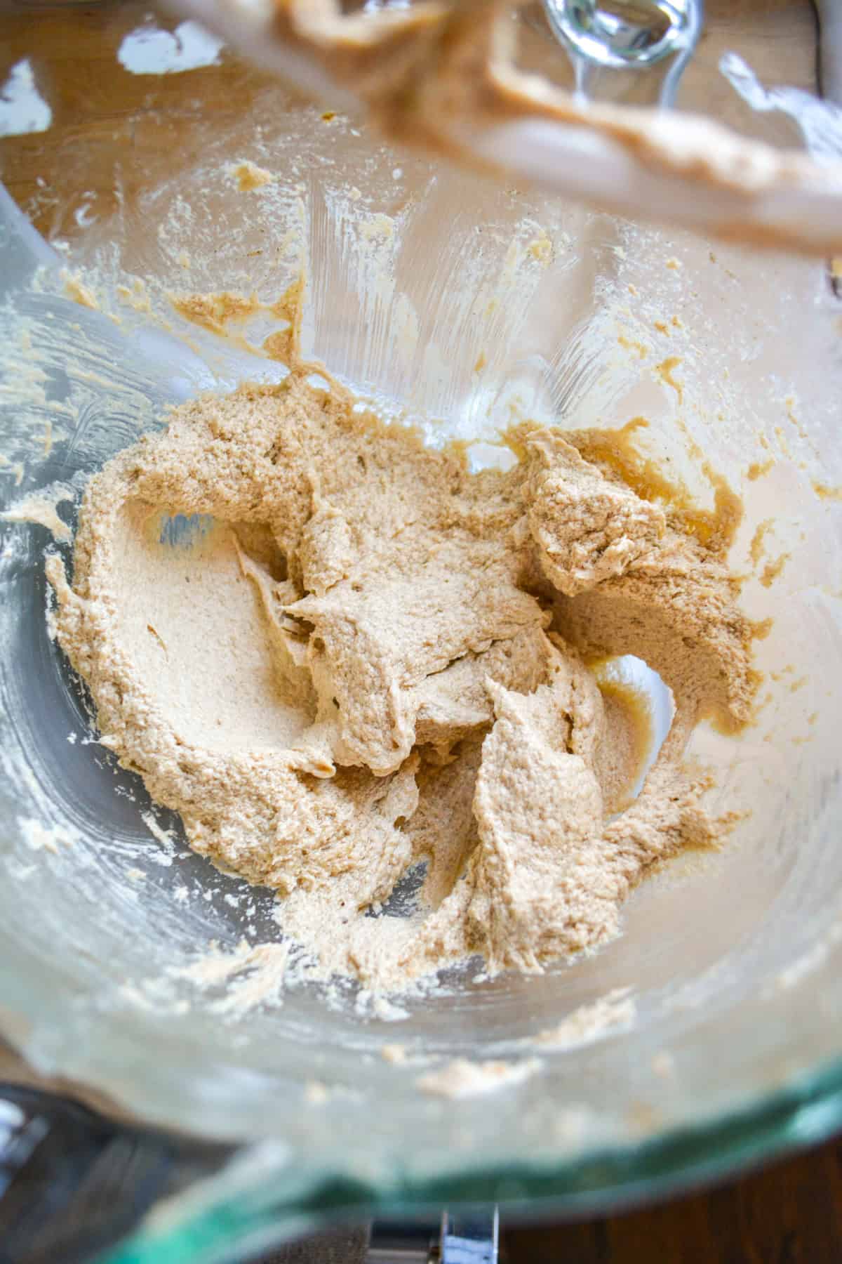 Butter and sugar creamed together in a glass mixing bowl.