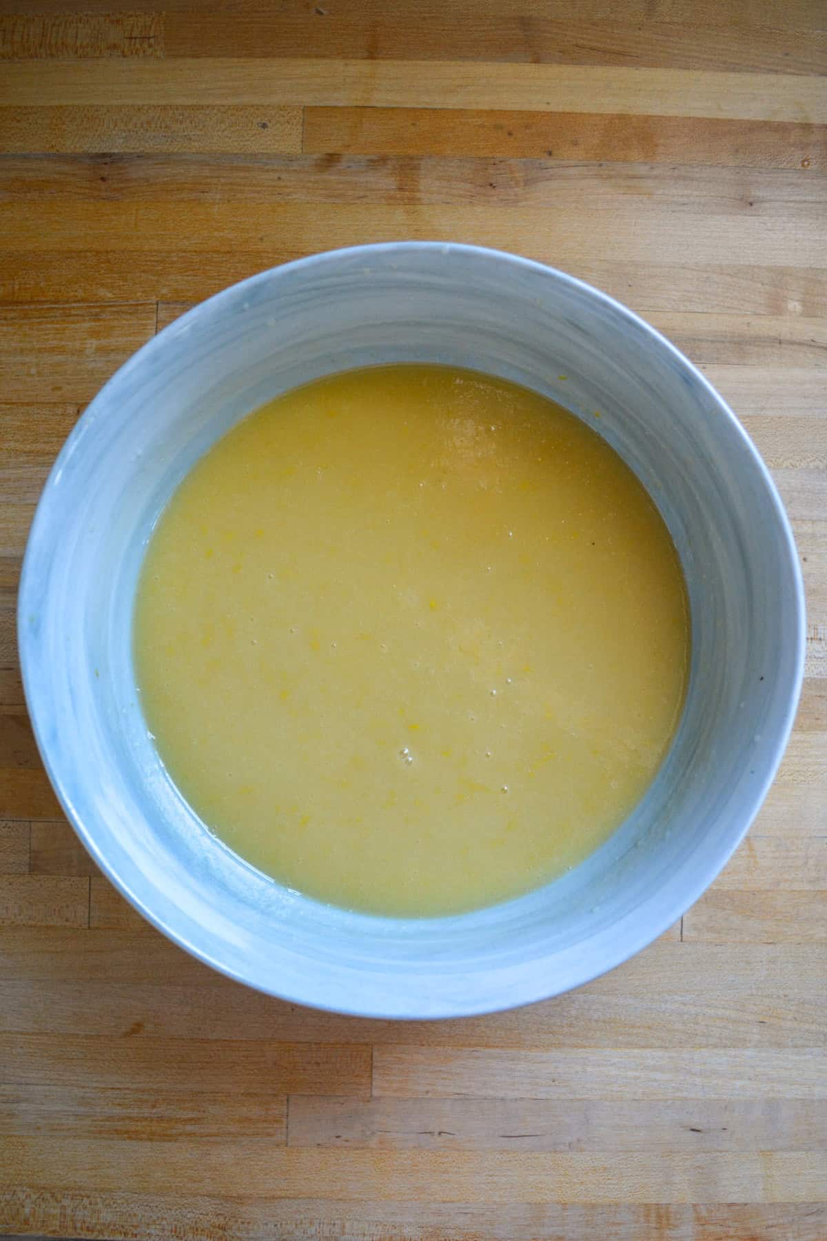 Wet ingredients for making a cake in a large mixing bowl.