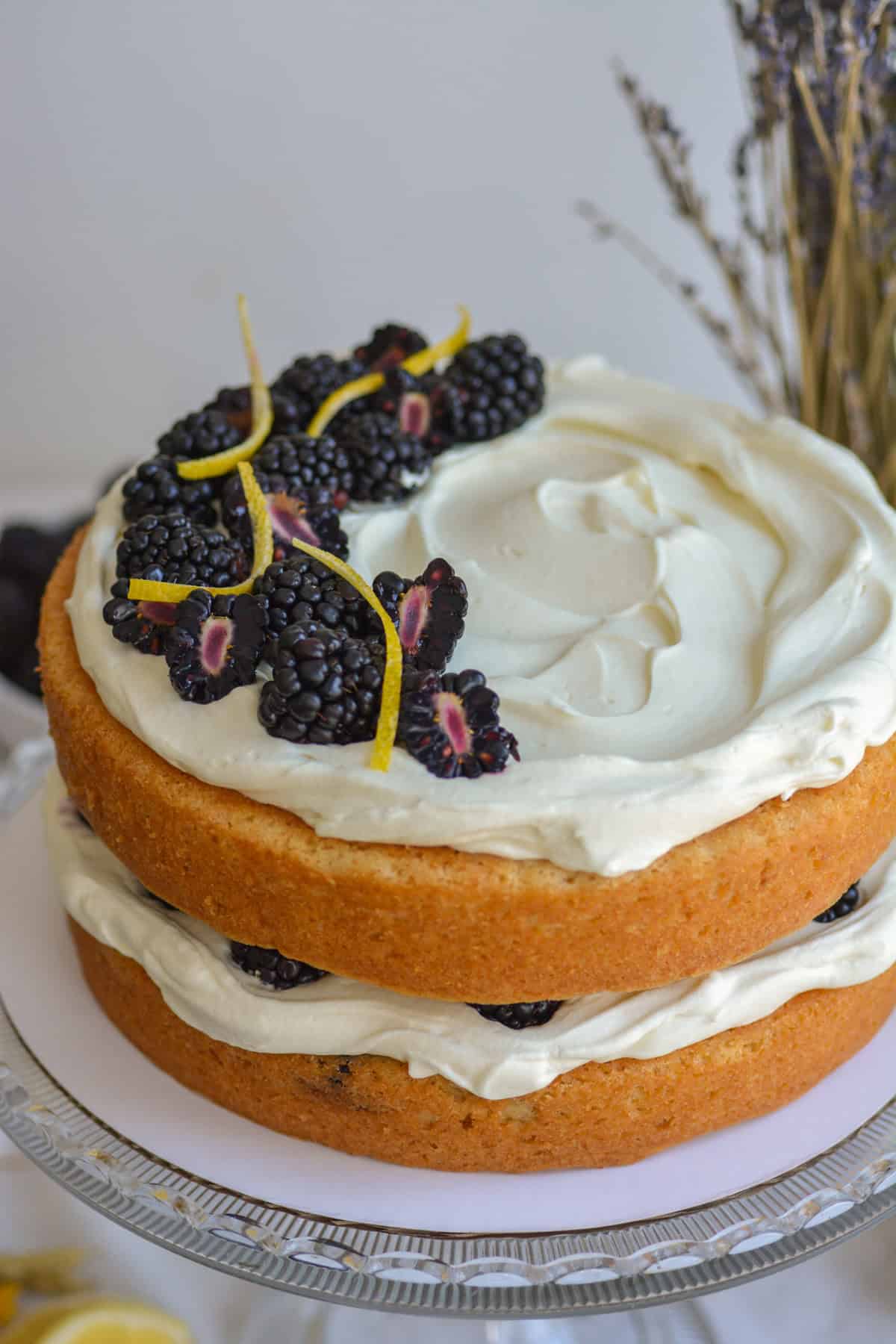A finished Vegan Blackberry Chantilly Cake on a cake stand.