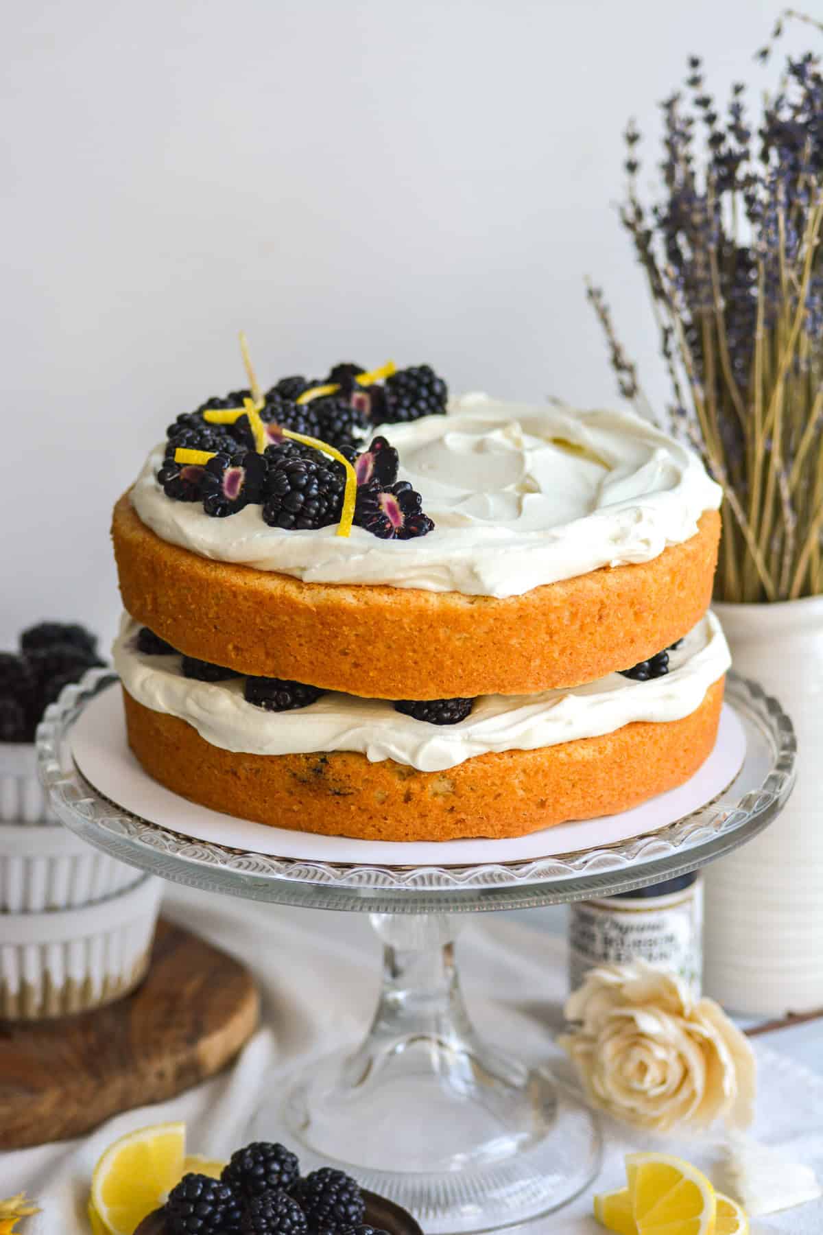 Vegan Blackberry Chantilly Cake on a glass cake stand.