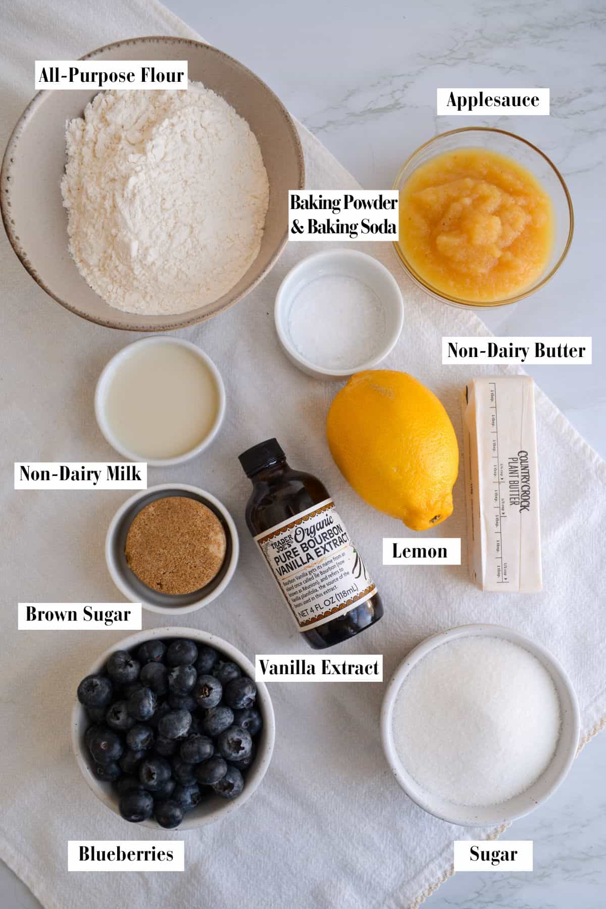 Ingredients for making this recipe in small bowls on a linen surface.