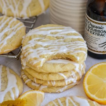 A stack of Vegan Lemon Cookies drizzled with lemon glaze.