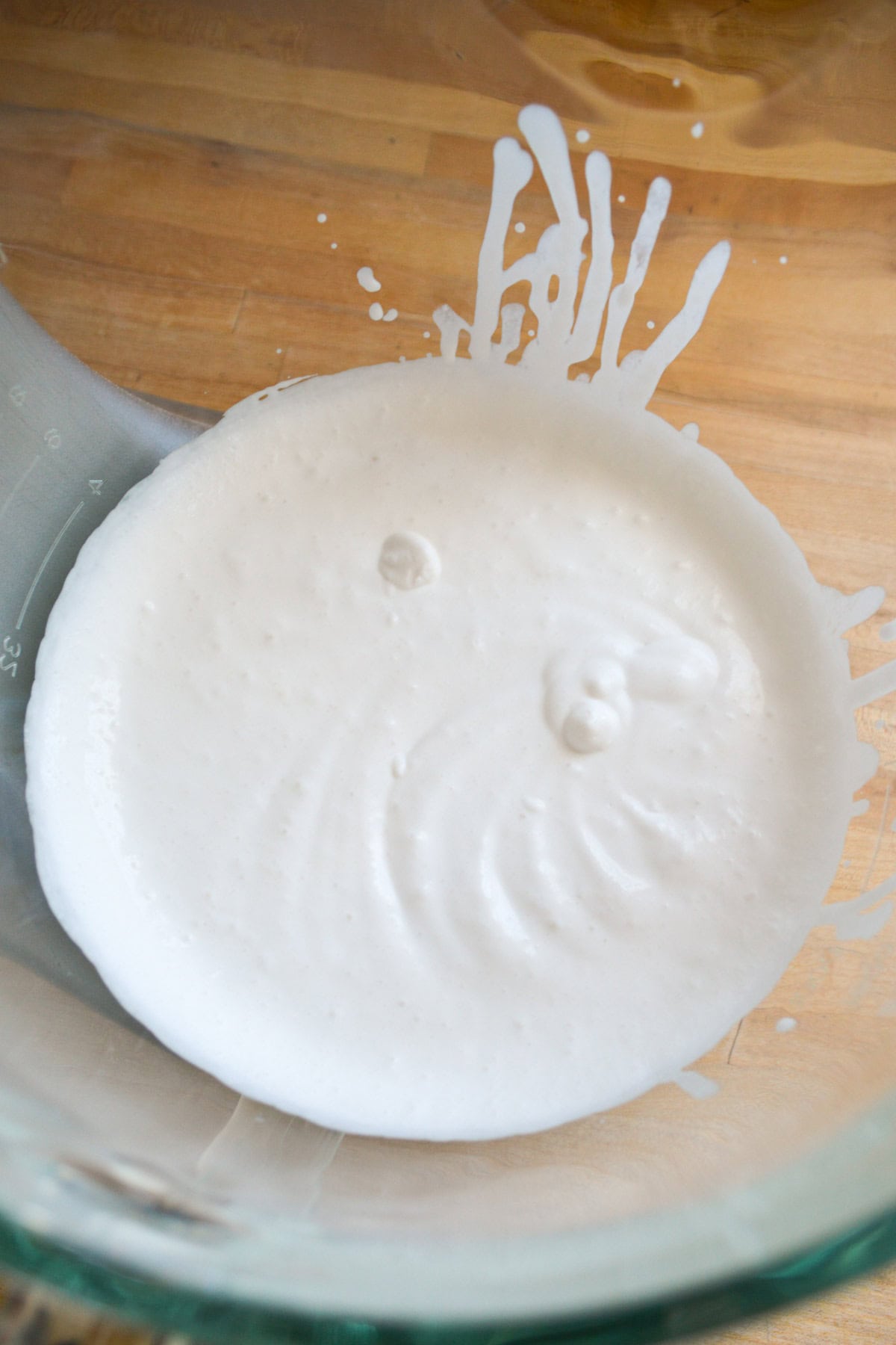 Whipping Vegan Heavy Cream in a glass bowl.