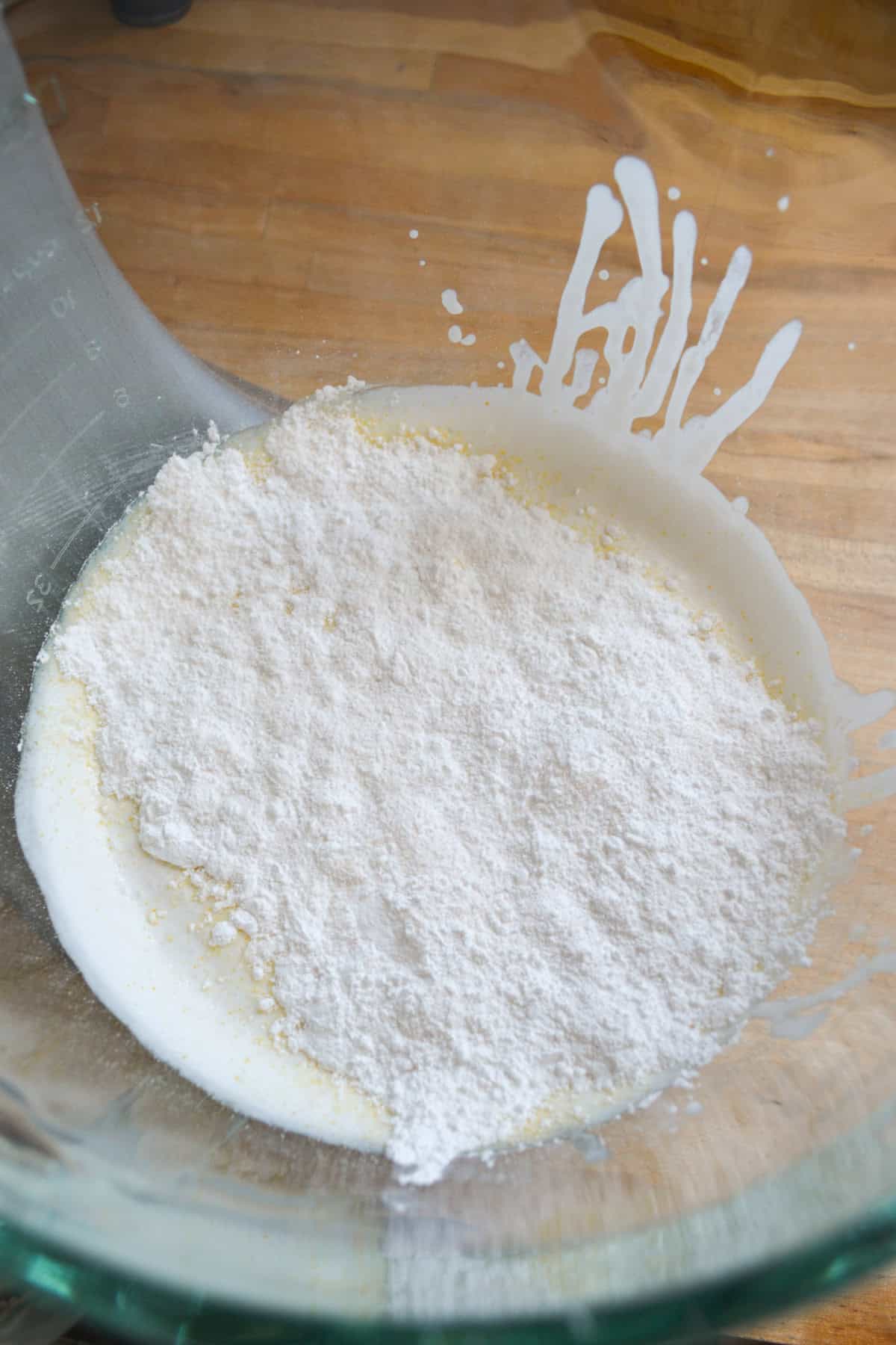 Adding powdered sugar and instant pudding mix to the cream.
