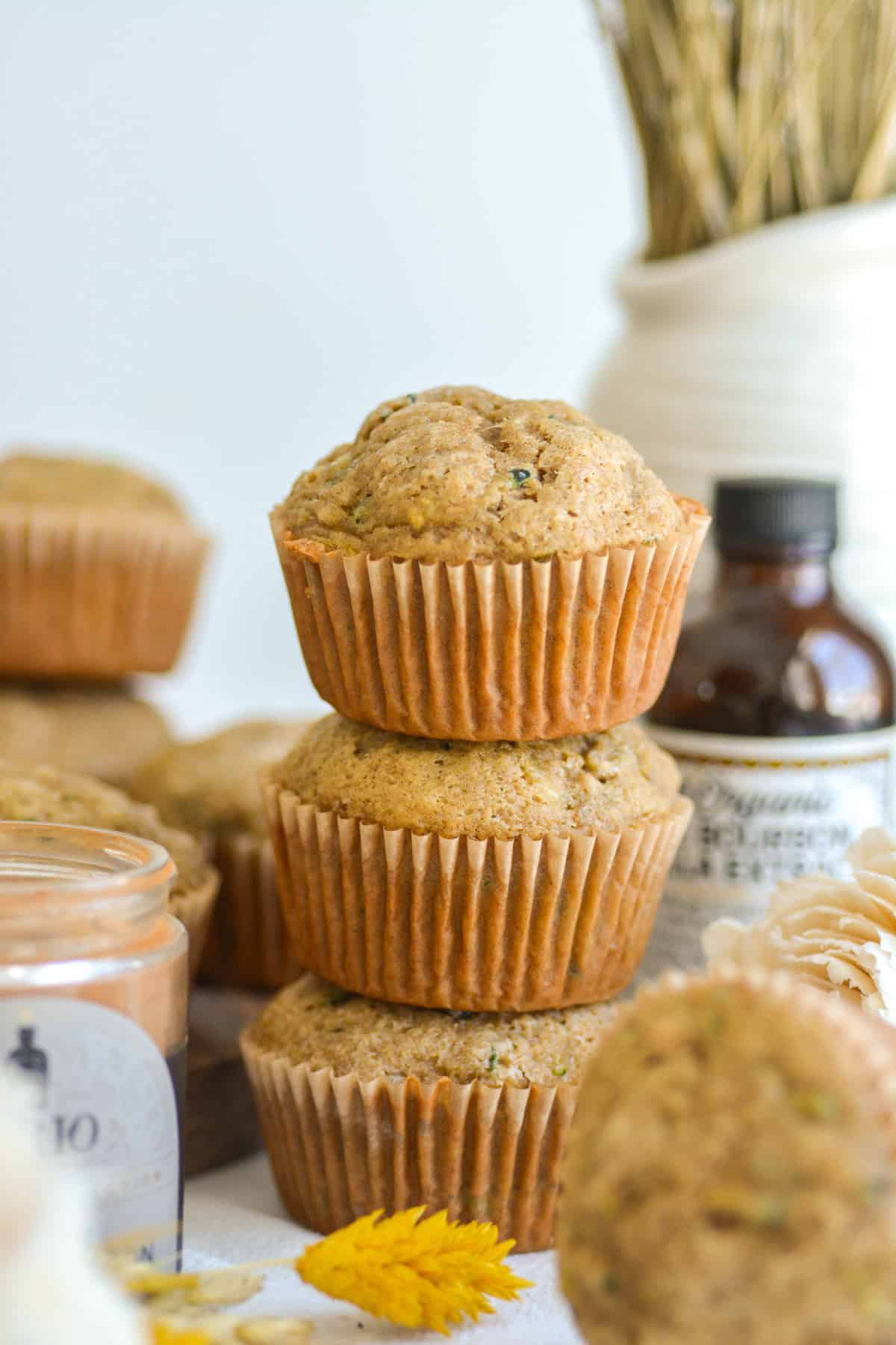 Three Vegan Zucchini Muffins stacked on top of each other.