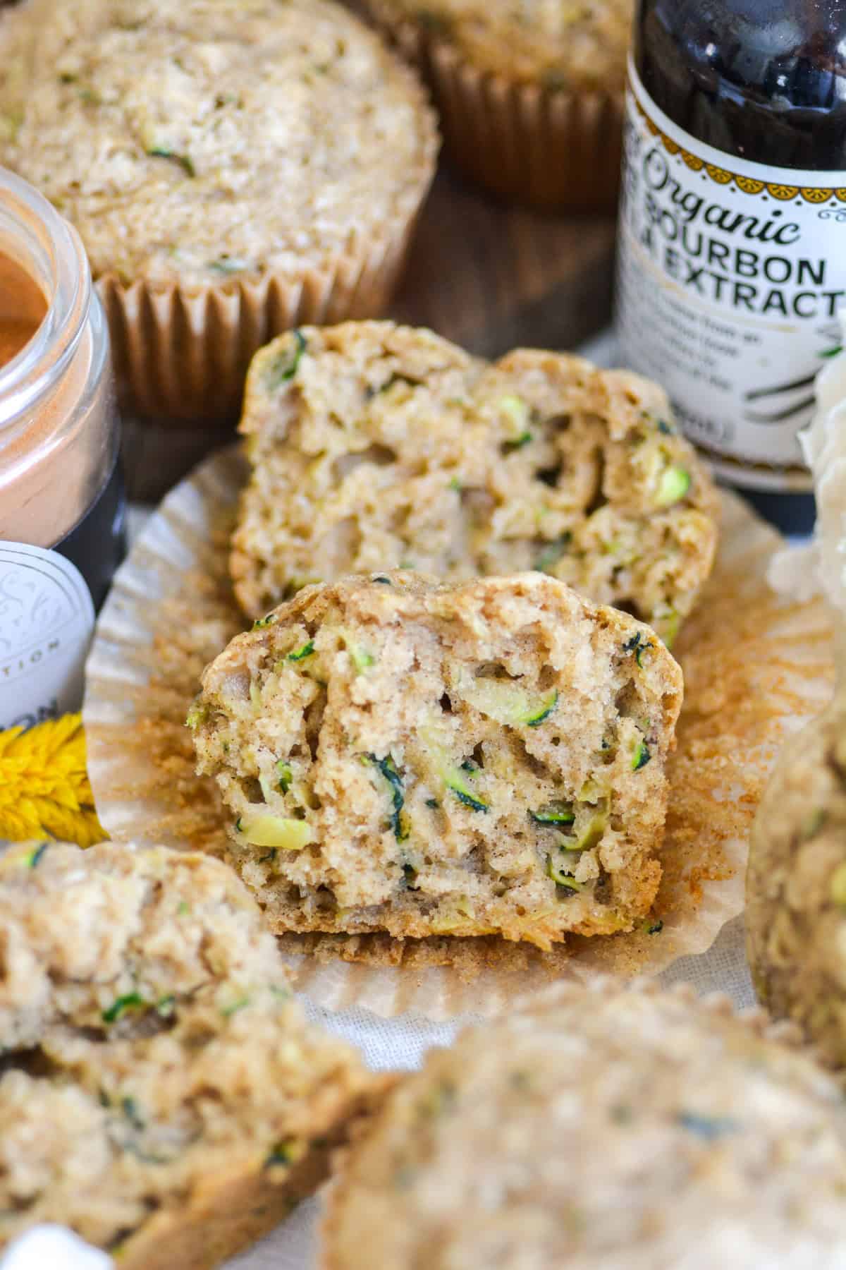 Vegan Zucchini Muffin cut in half on a parchment liner.