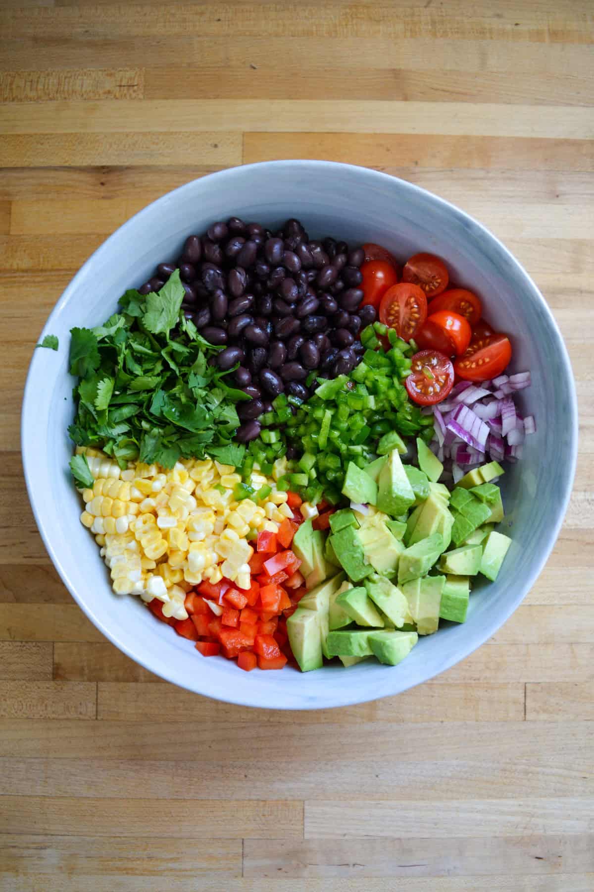 Chopped salad ingredients in a large mixing bowl.