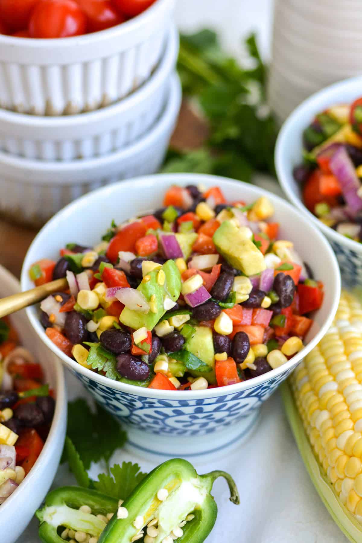 Black Bean Corn Salad in a small bowl with a spoon in it.