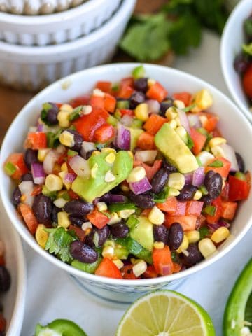 Black Bean Corn Salad in a bowl on a linen surface.