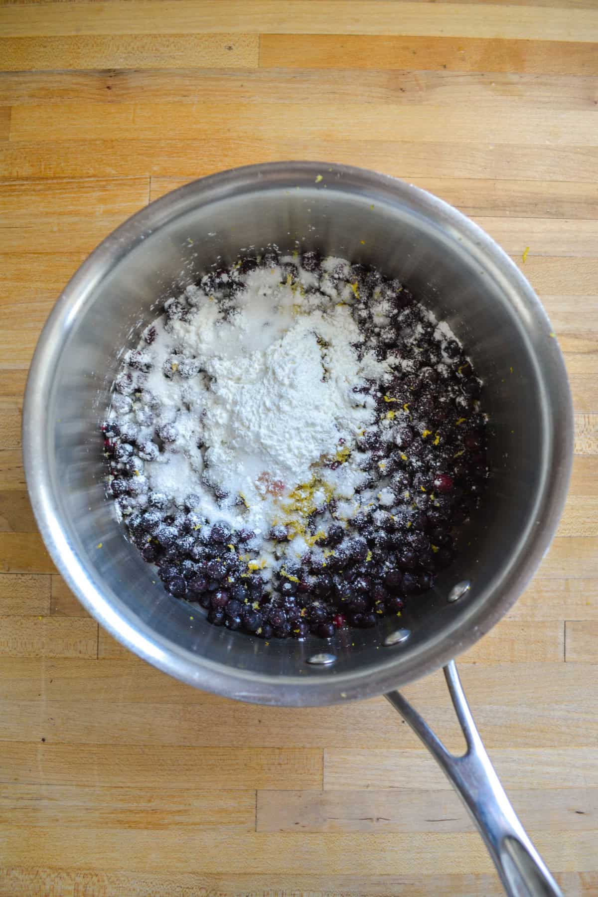 Frozen blueberries, sugar and cornstarch in a pot.