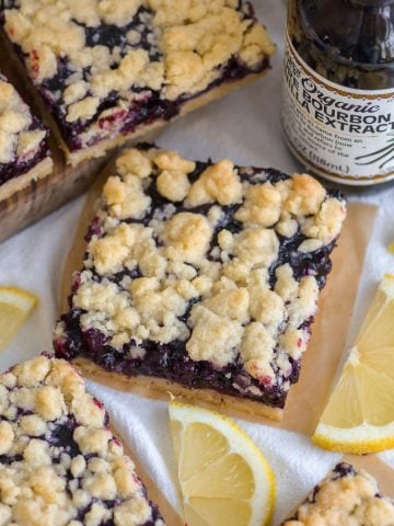 Blueberry Crumble Bars on a linen surface.