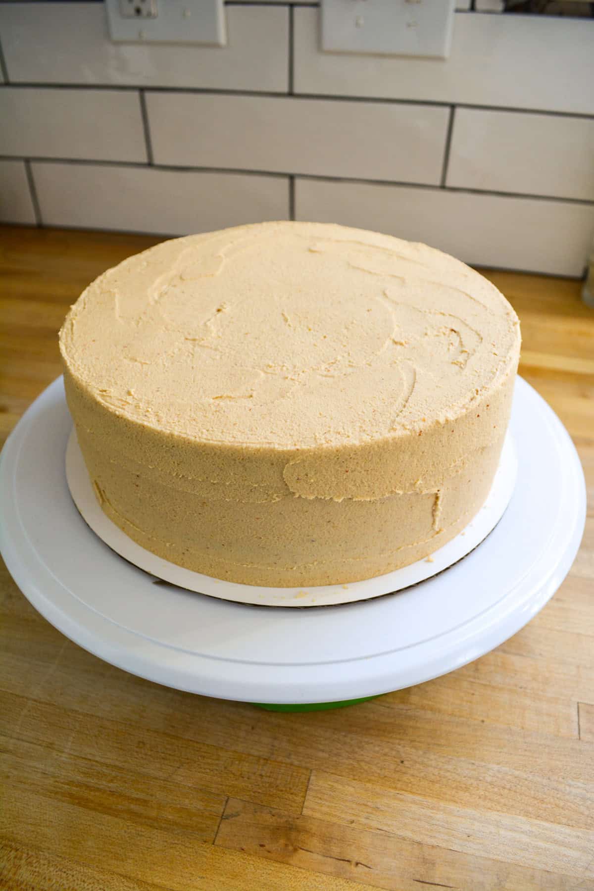 A cake frosted with peanut butter frosting.