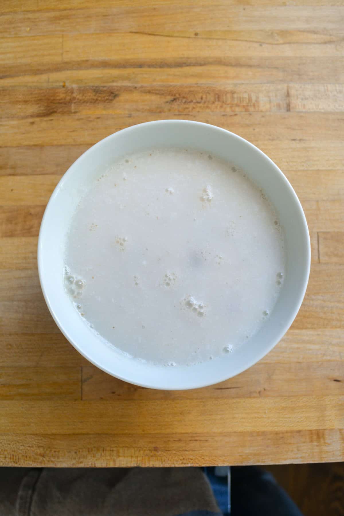 Chocolate chips and non-dairy milk in a bowl.