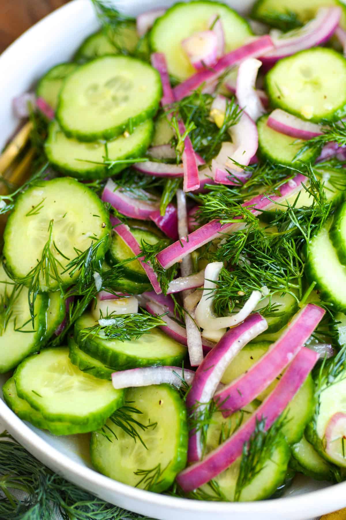 Close up of Cucumber Dill Salad with sliced onions.