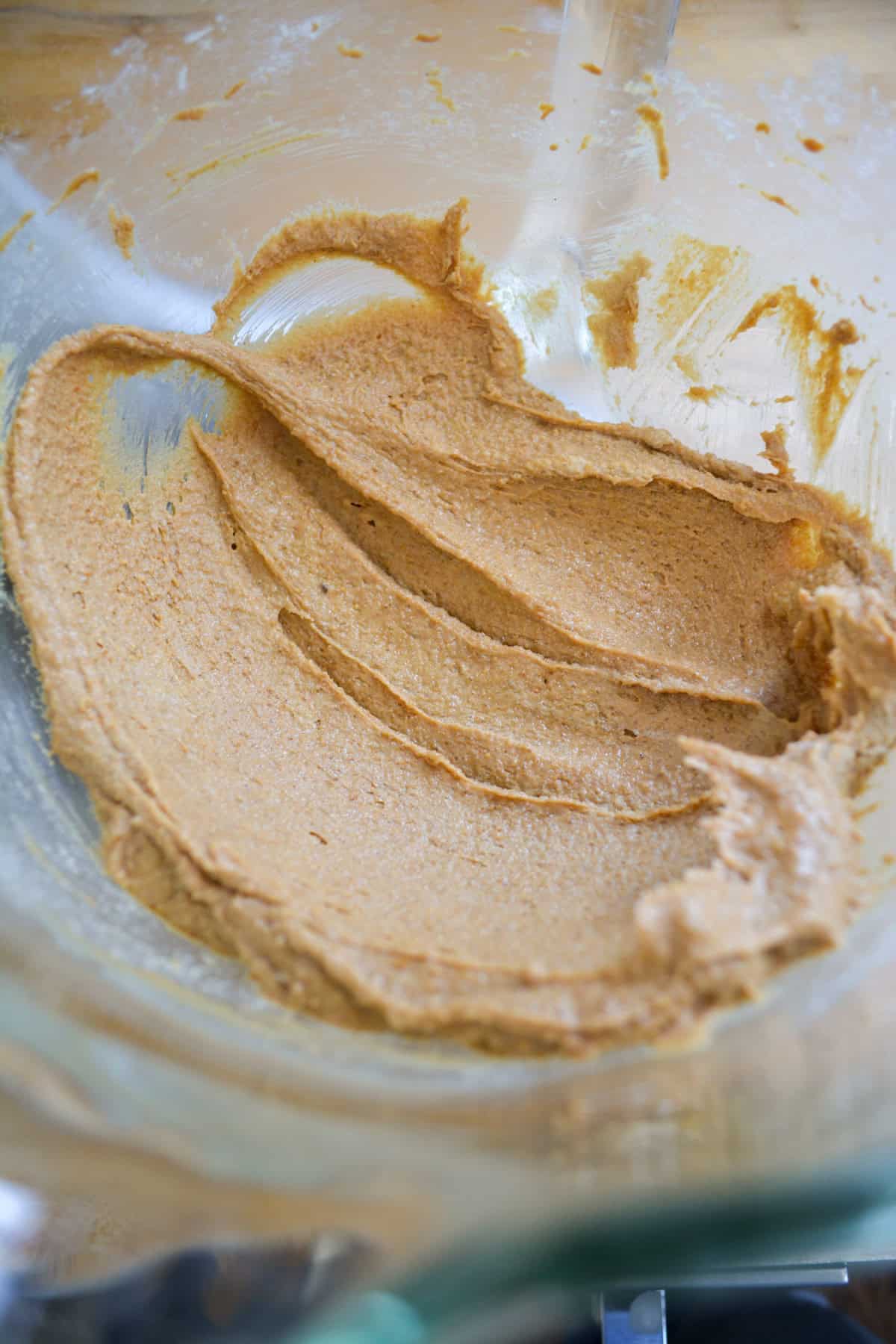 butter, brown sugar and peanut butter creamed together in a glass bowl.