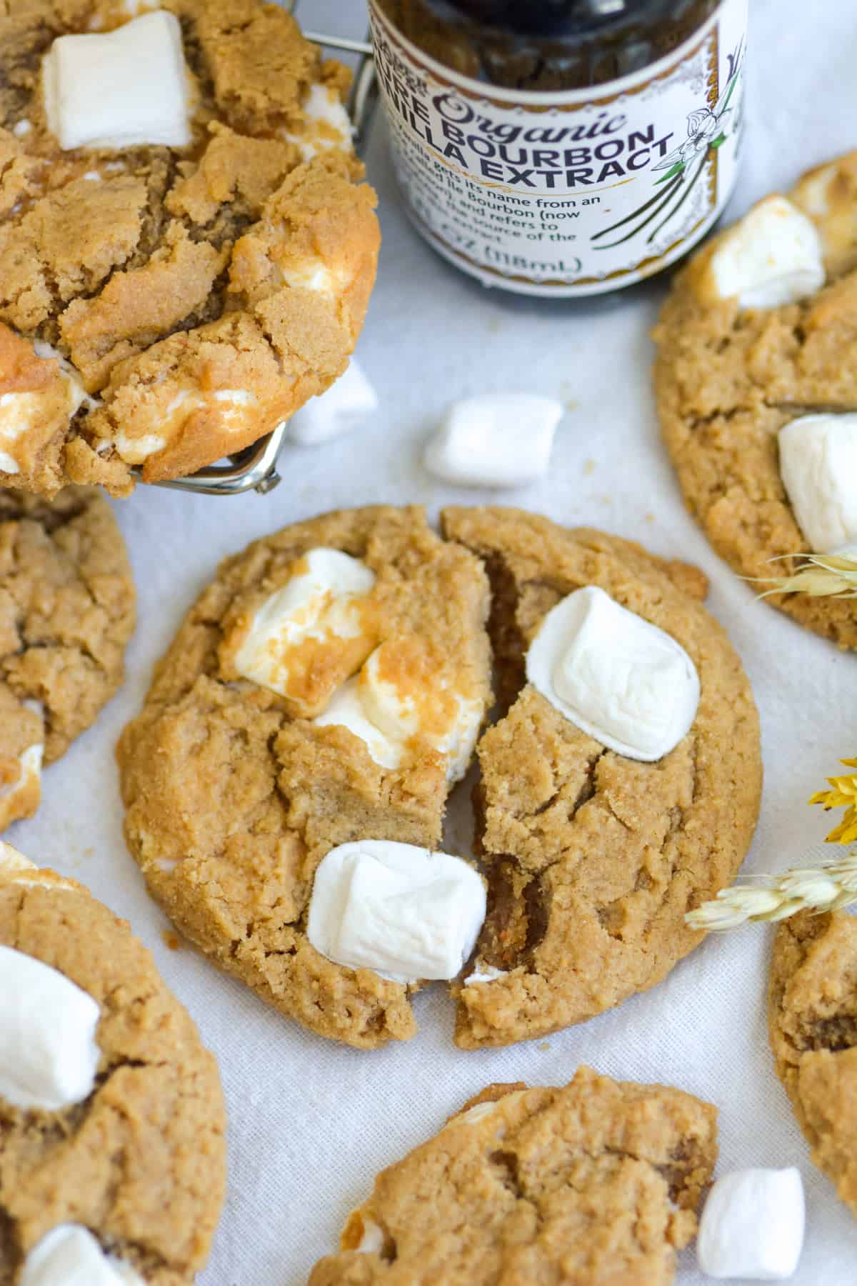 A Fluffernutter Cookie broken in half on a linen surface.