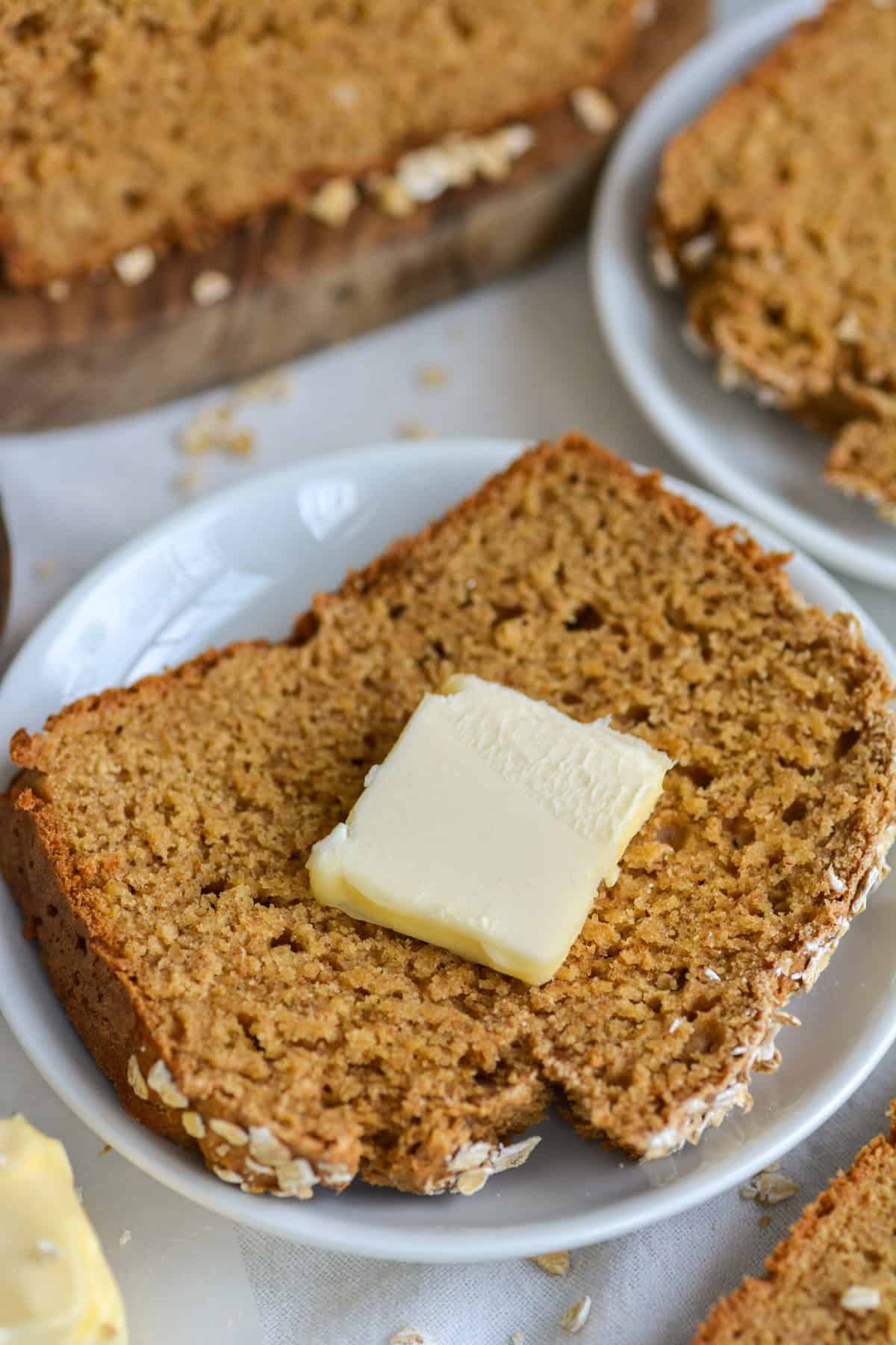 A slice of Irish Brown Bread and a pat of butter on top.