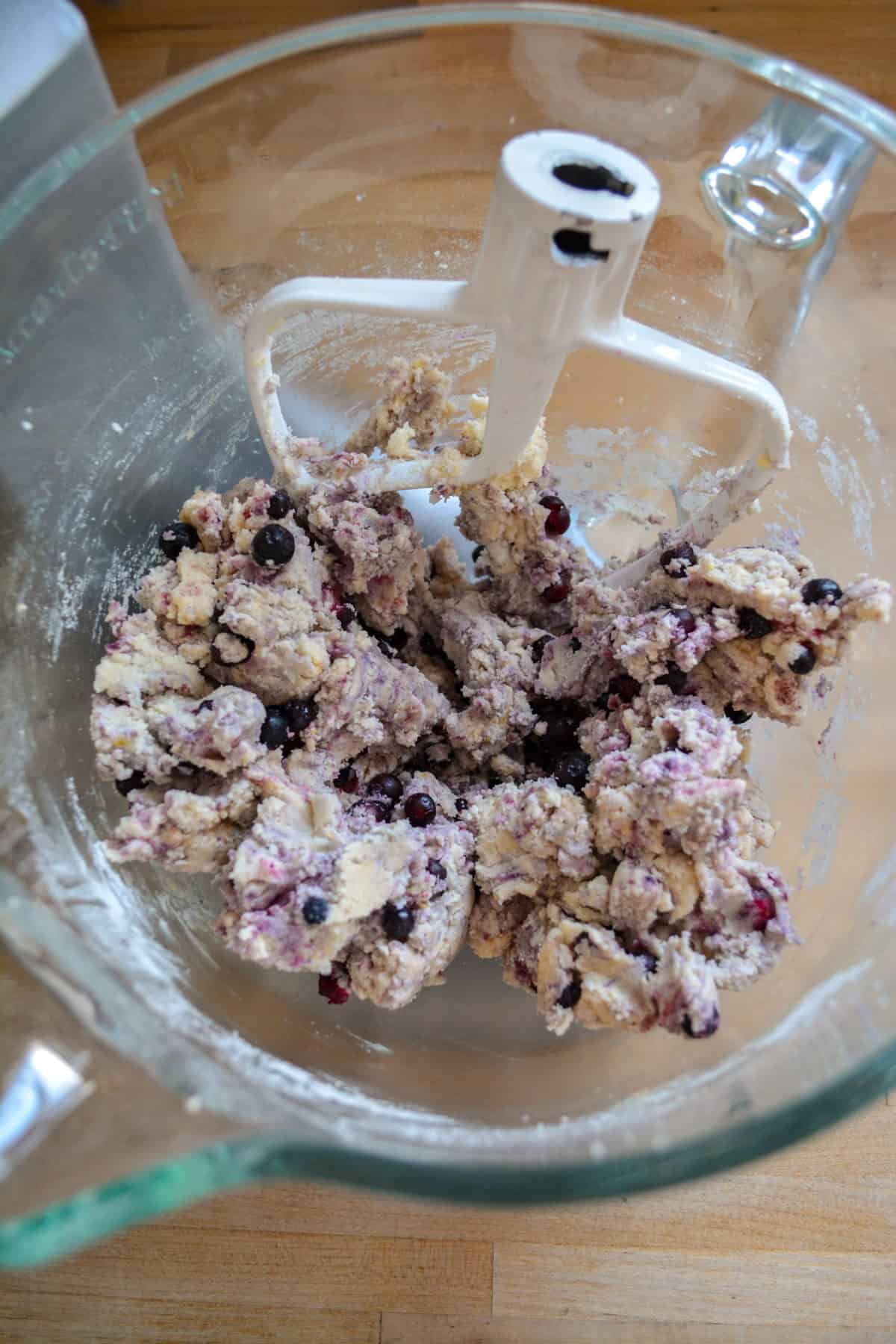 Dry ingredients and frozen blueberries added into the cookie dough.