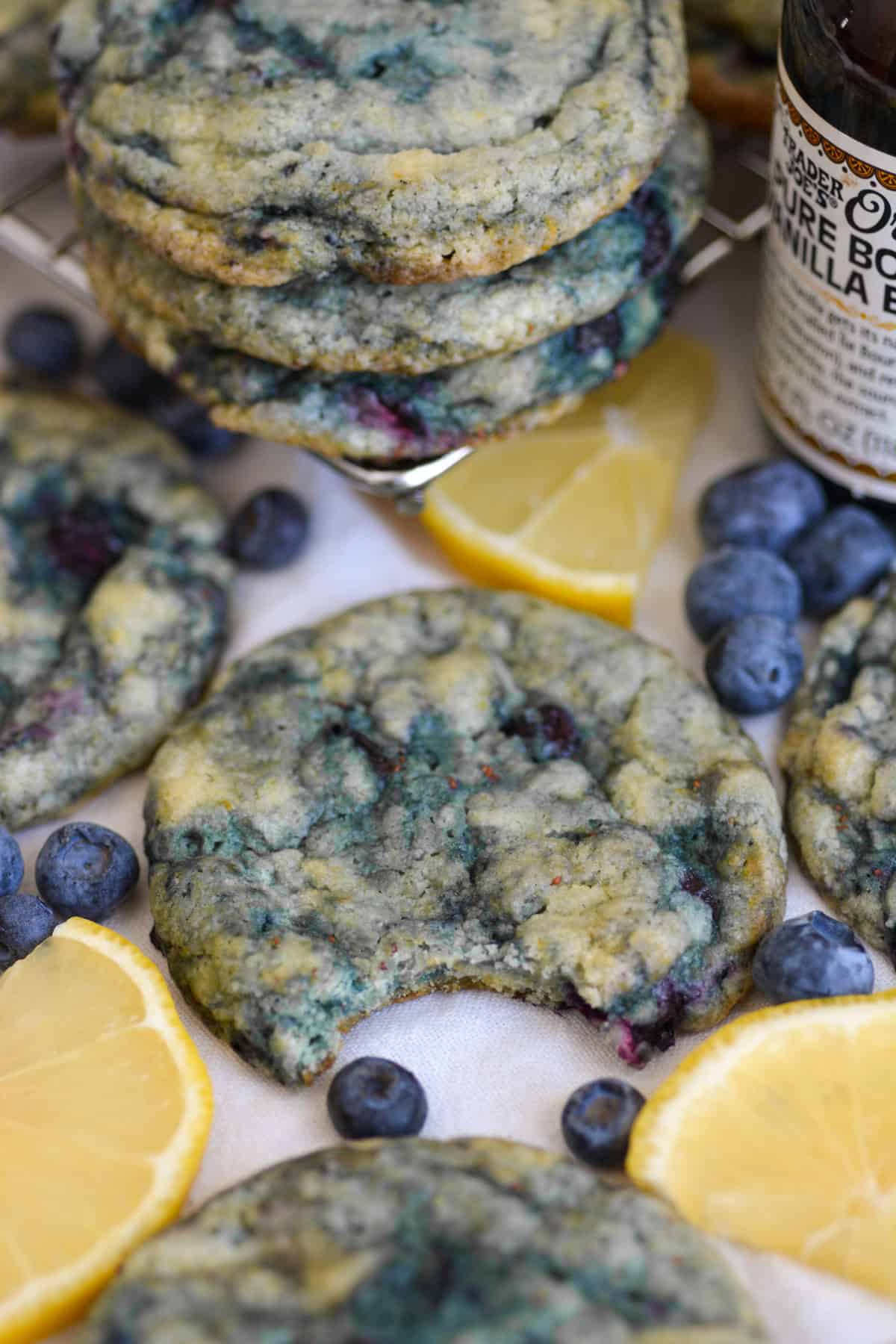 A Vegan Blueberry Lemon Cookie with a bite taken out of it on a linen cloth.