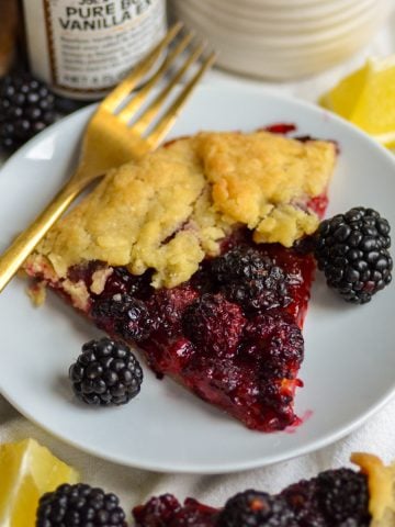 A slice of blackberry Galette on a small plate.
