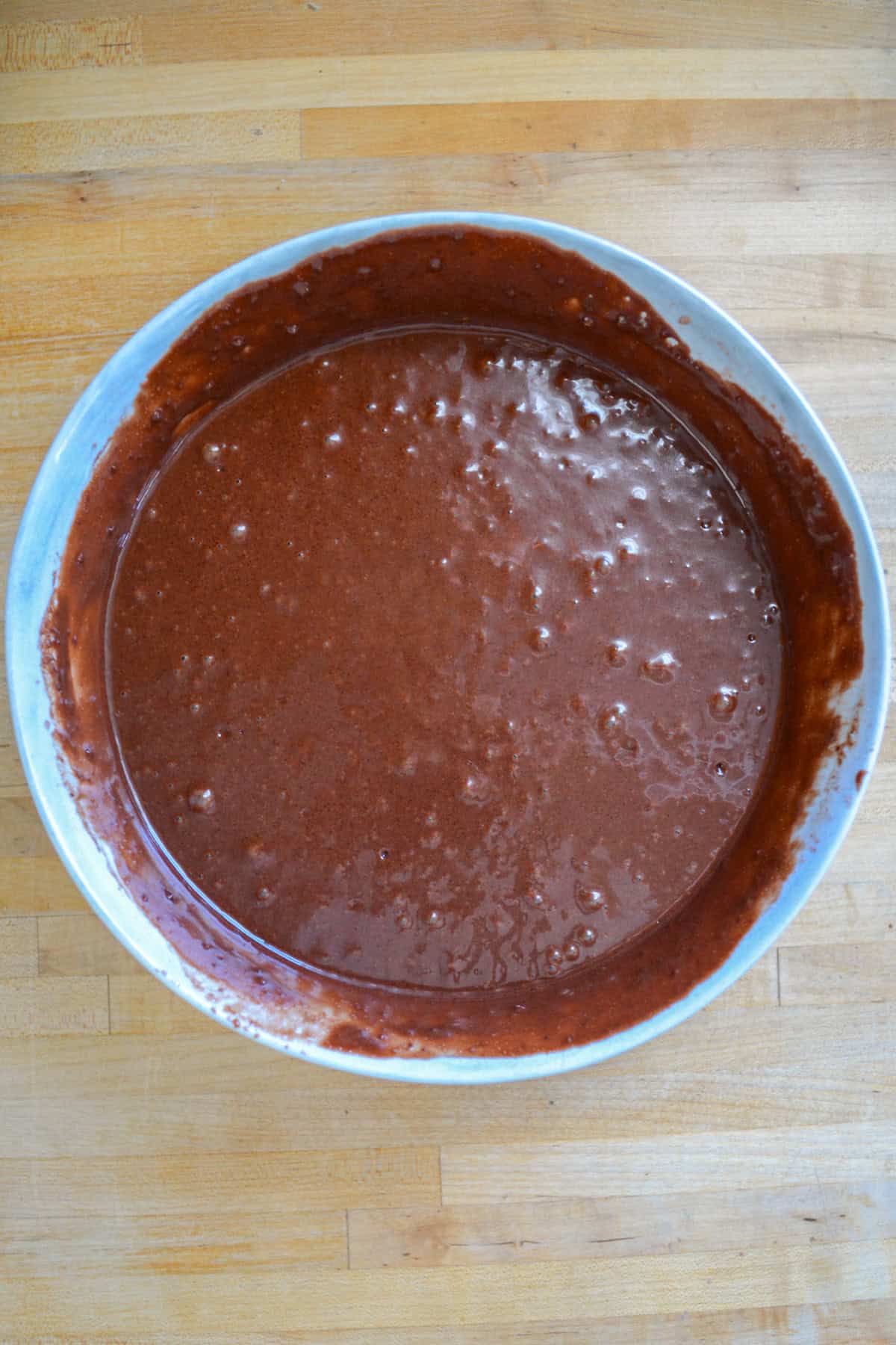 Chocolate cake batter in a large mixing bowl.