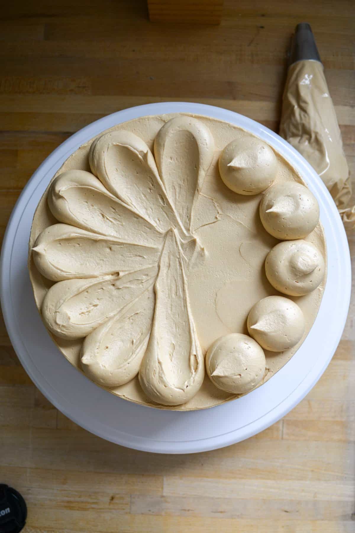 Dollops of espresso frosting around the perimeter of the chocolate cake.