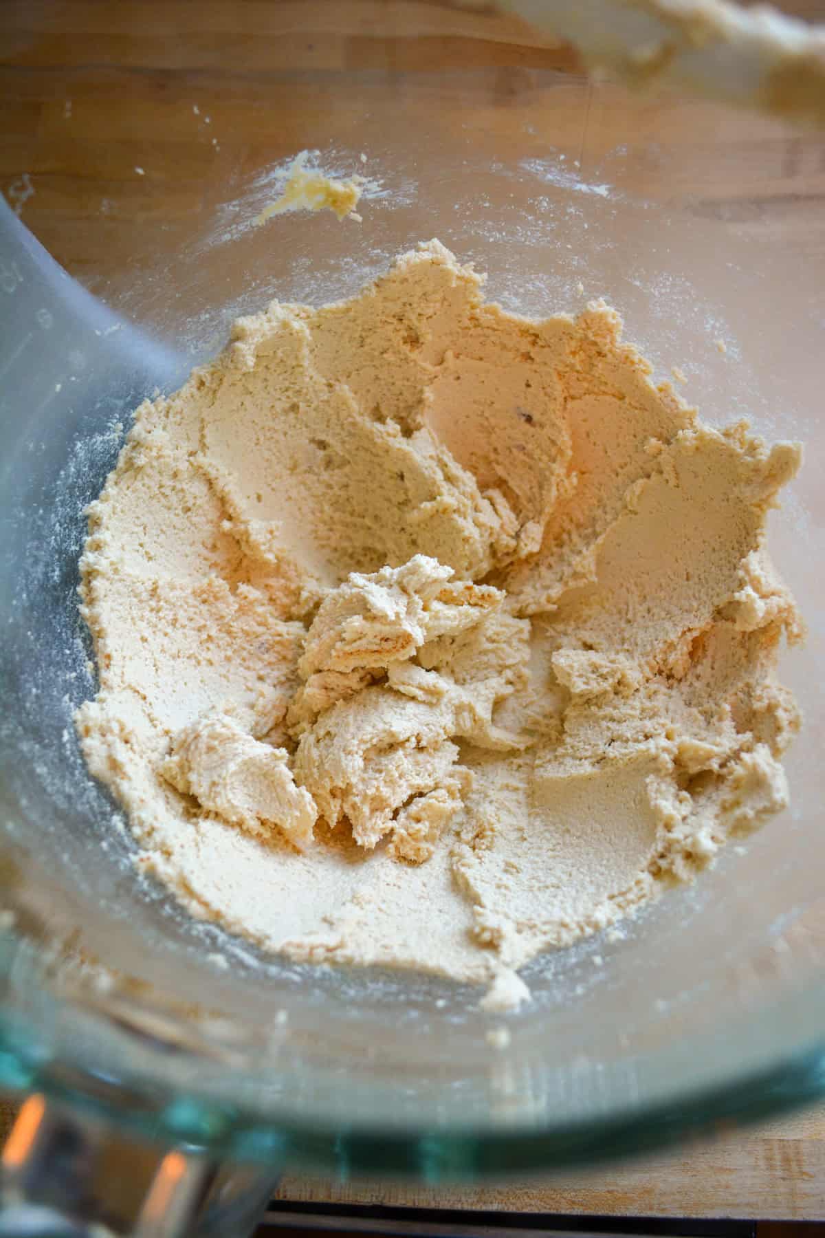 Butter and brown sugar creamed together in a glass mixing bowl.