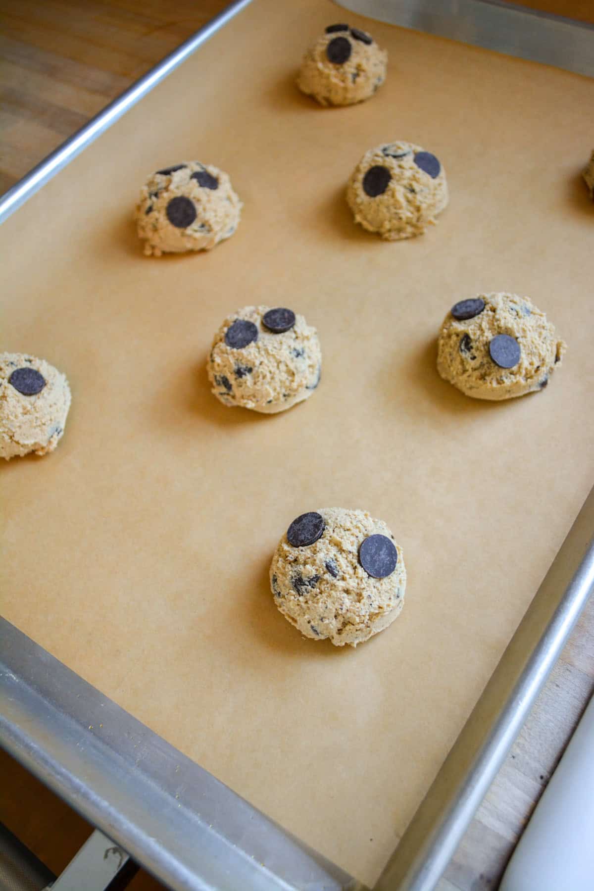 Vegan Coffee Chocolate Chip Cookies on a parchment-lined baking sheet.