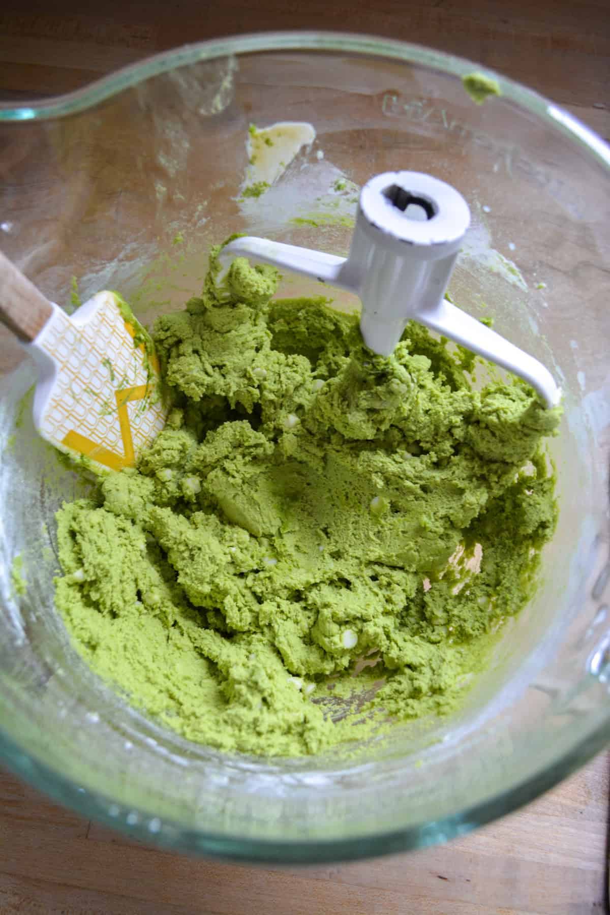 Matcha cookie dough in a glass bowl.