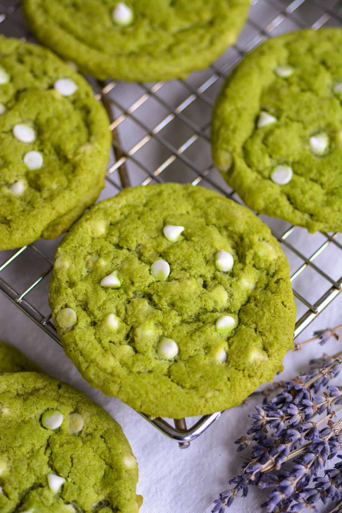 Vegan Matcha White Chocolate Chip Cookies on a wire cooling rack.