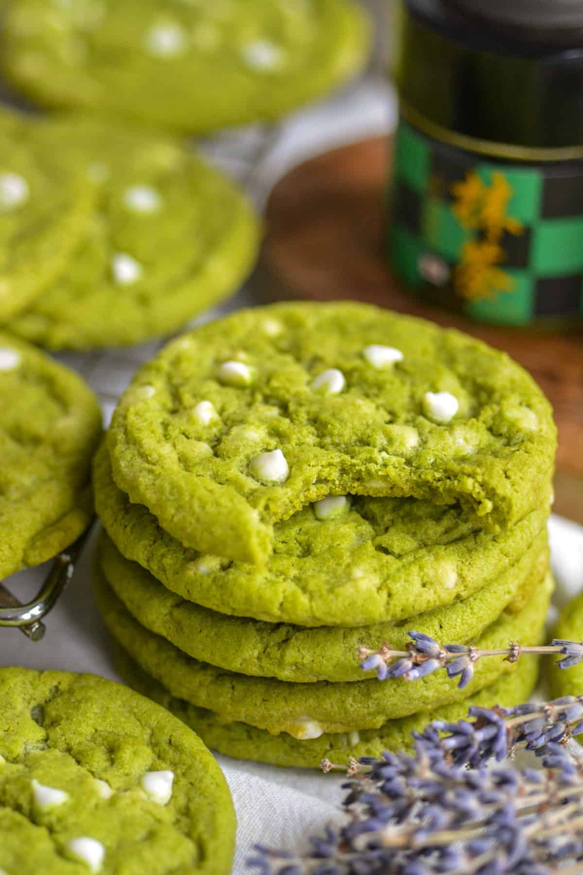 A stack of Vegan Matcha White Chocolate Chip Cookies on a linen surface.
