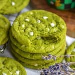 A stack of Vegan Matcha White Chocolate Cookies with a bite taken out of the top cookie.