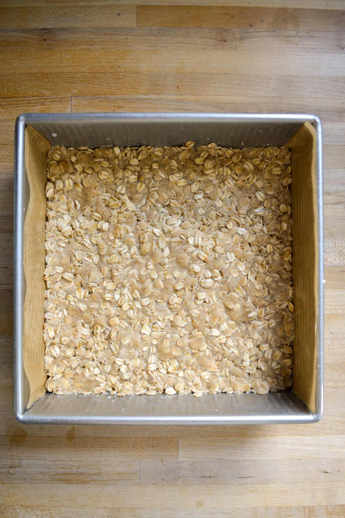 Oatmeal Crust pressed into a square baking pan.