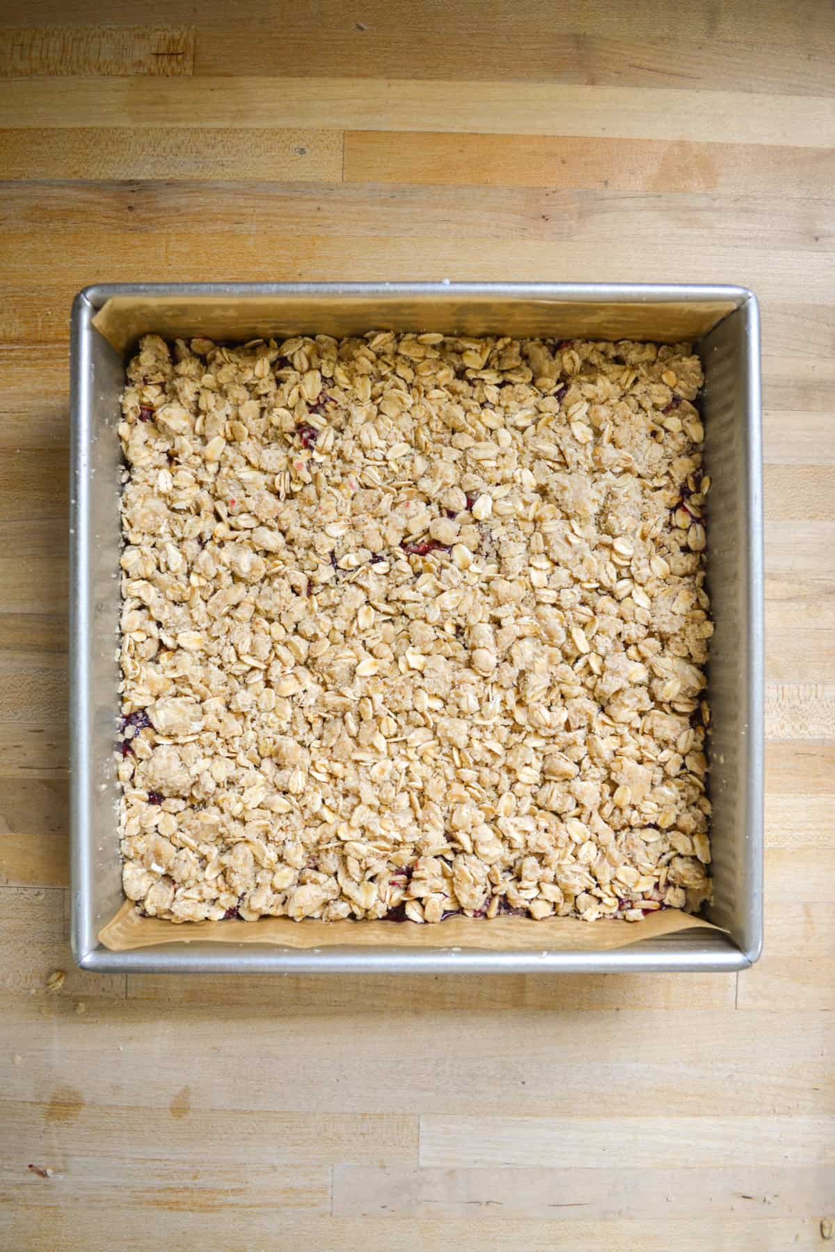 Blackberry Oat Bars in a square pan ready to bake.