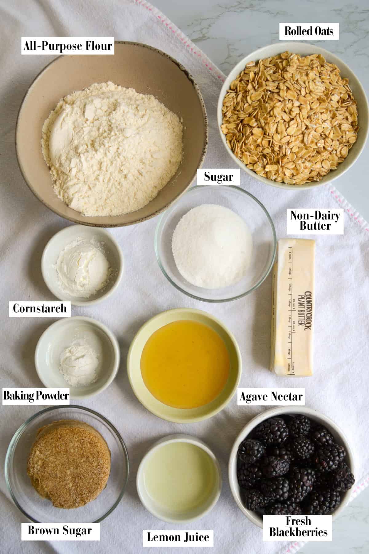 Ingredients for this recipe in small bowls on a linen surface.