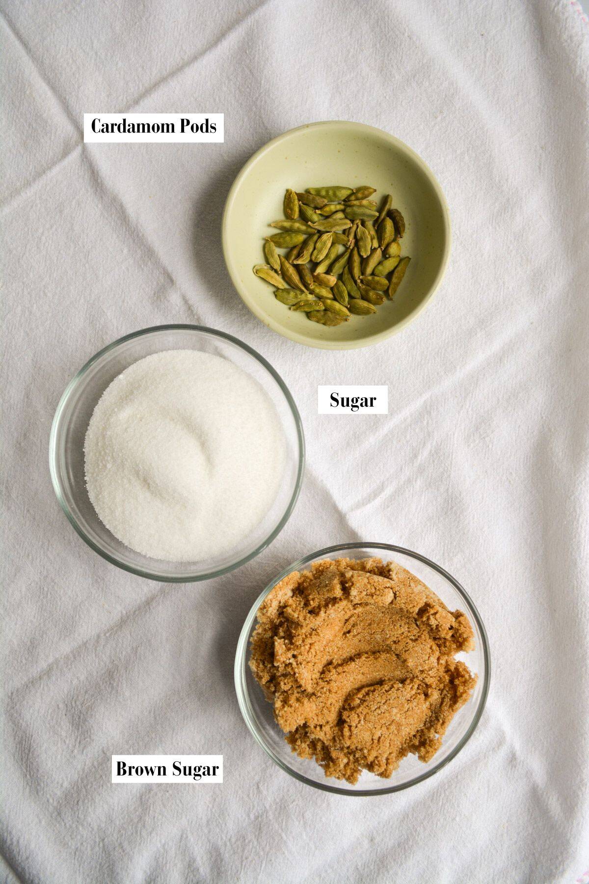 Small bowls on a linen surface filled with ingredients.