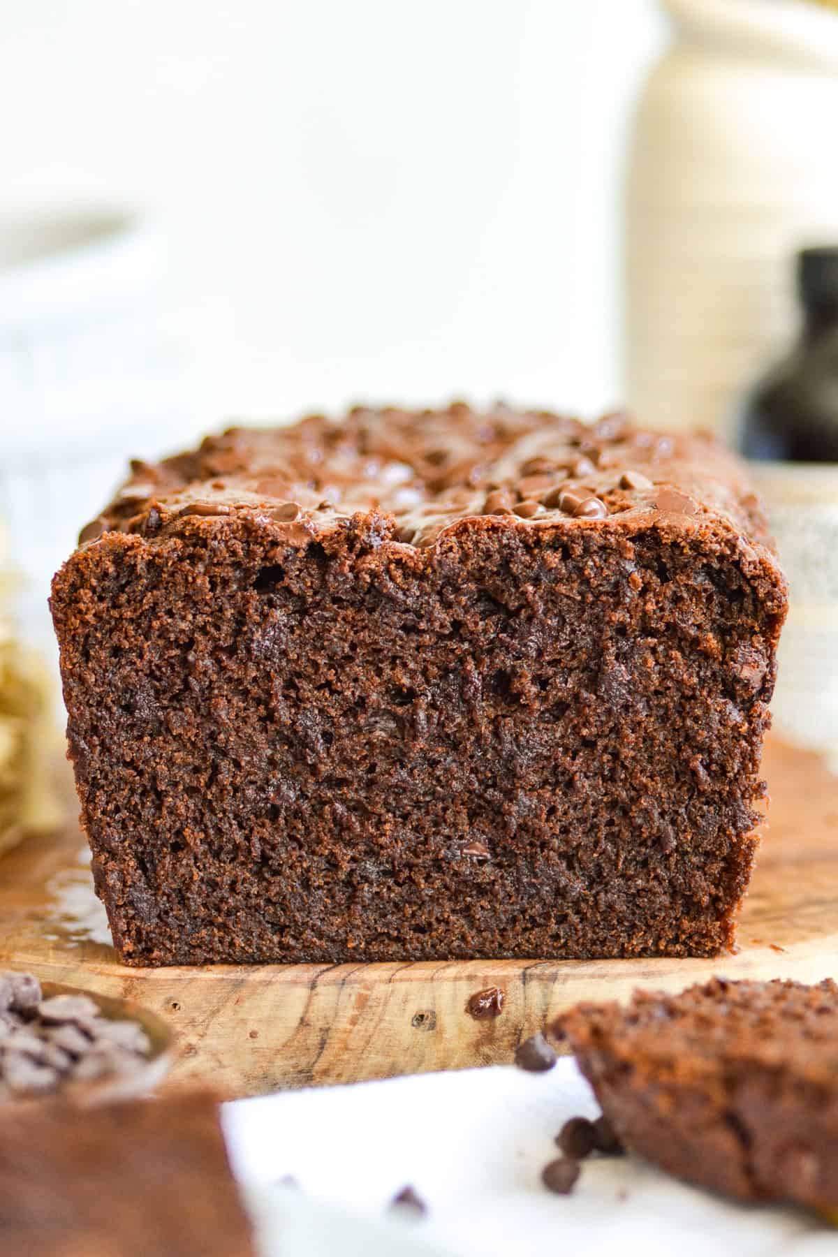 A Chocolate Loaf Cake on a wooden cutting board.
