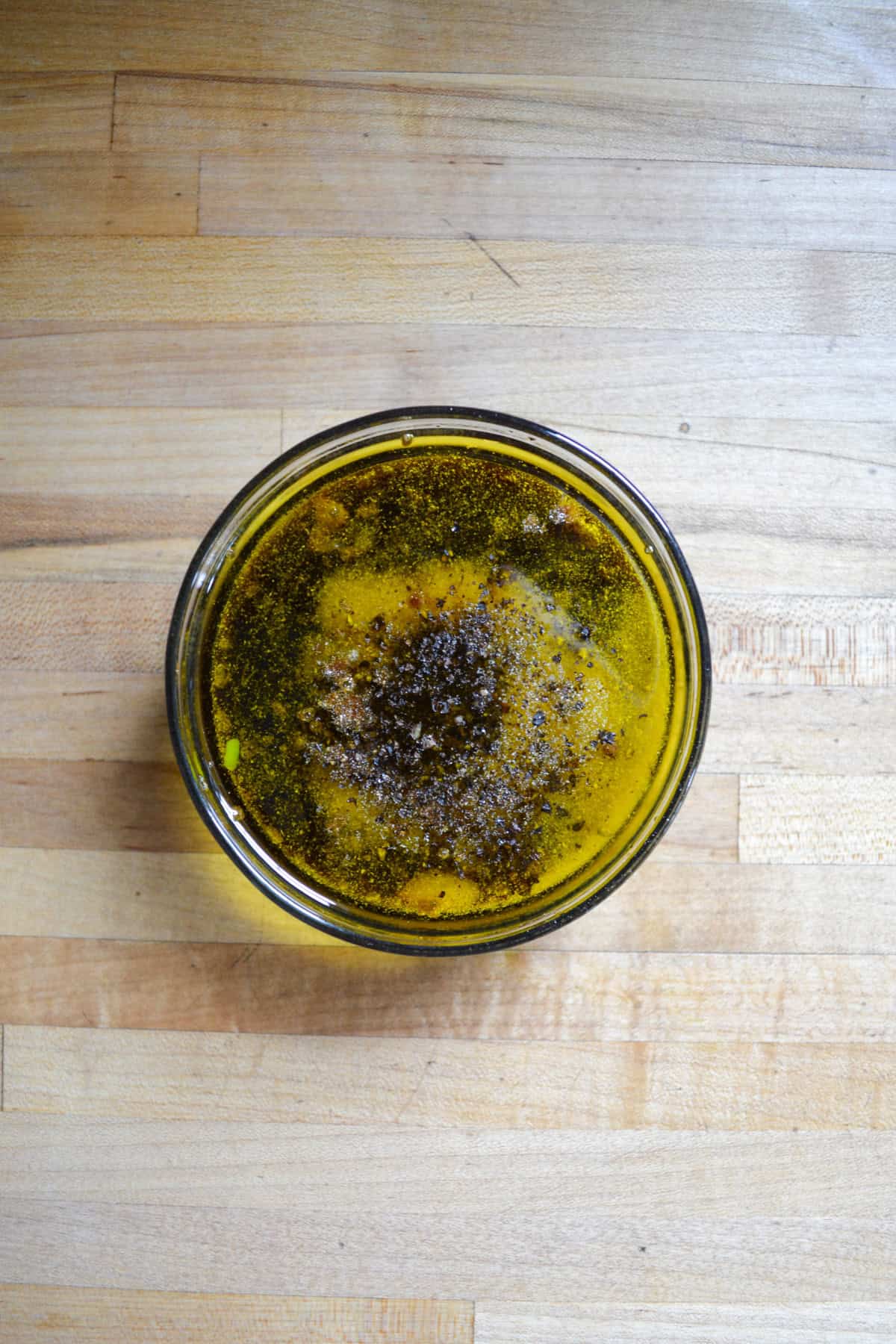 Balsamic vinegar, olive oil and spices in a bowl.