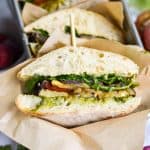 A Roasted Vegetable Sandwich that has been cut in half to show the interior.