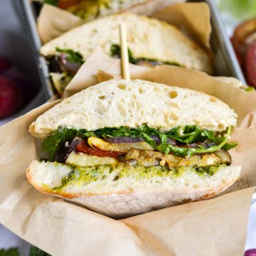 A Roasted Vegetable Sandwich that has been cut in half to show the interior.