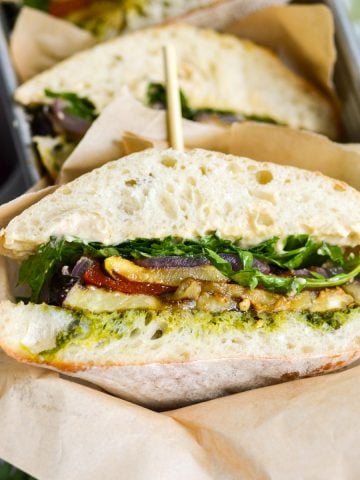 A Roasted Vegetable Sandwich that has been cut in half to show the interior.