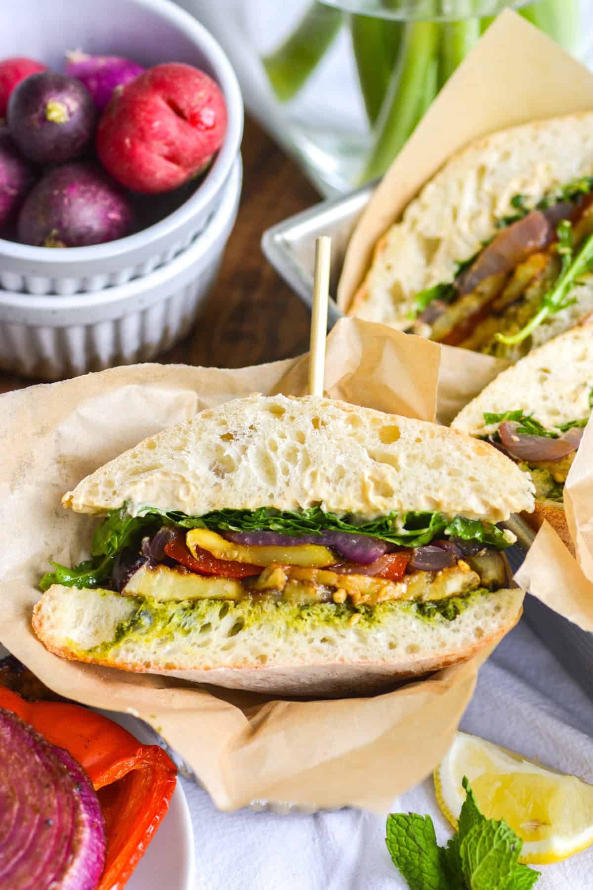 Roasted vegetable sandwich on a linen surface.