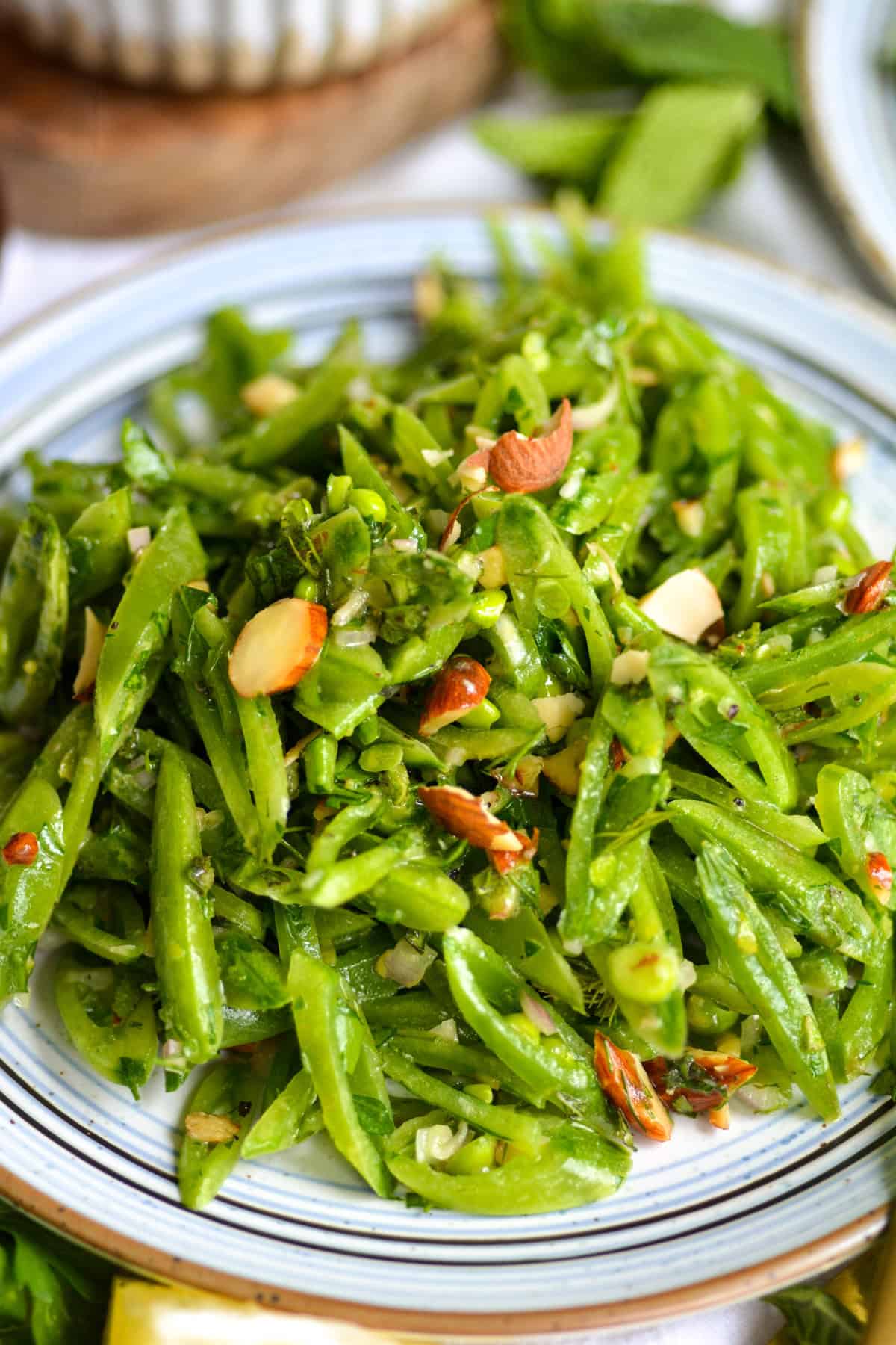 Sugar Snap Pea Salad topped with roasted almonds.