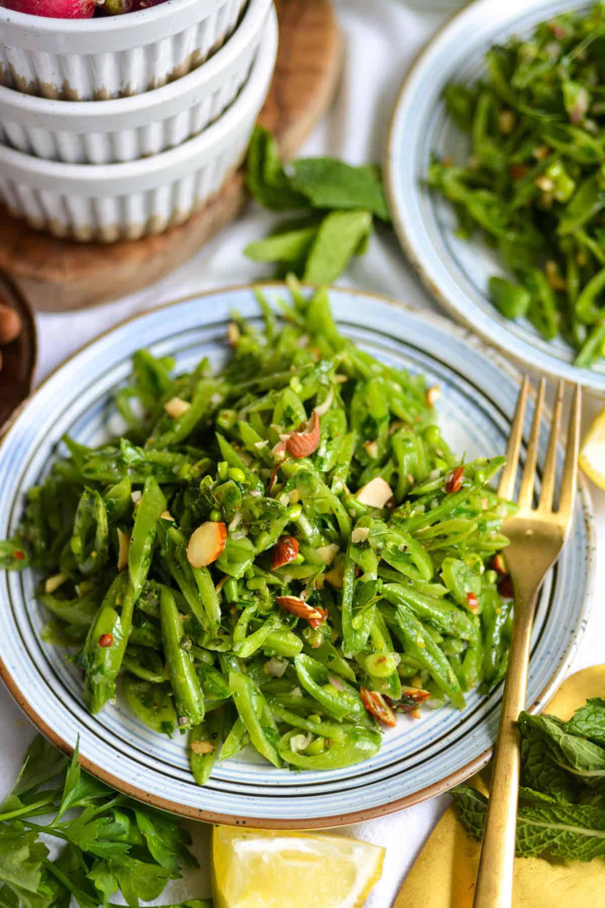 Sugar Snap Pea Salad on a plate with a gold fork.