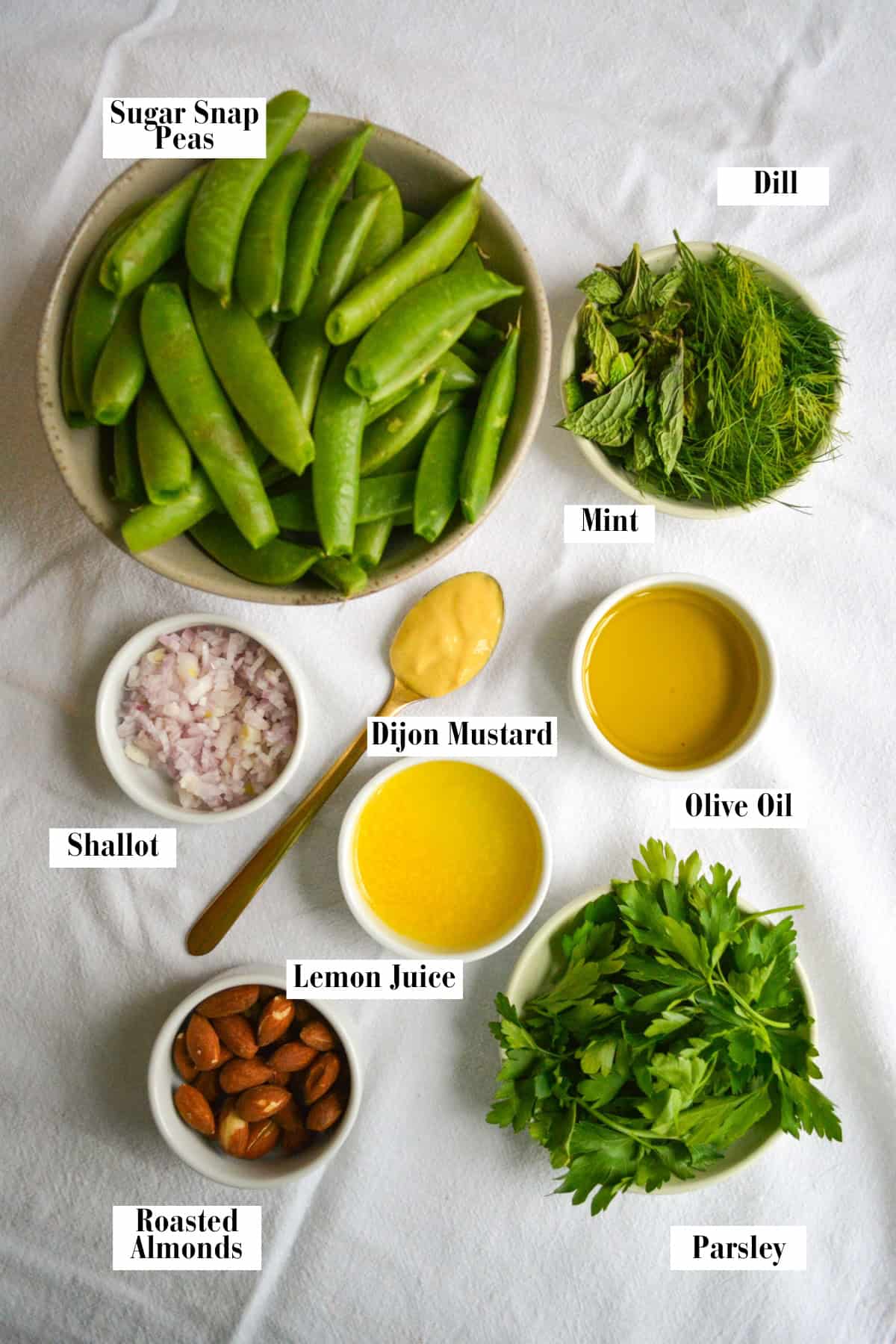 Ingredients for making this recipe in small bowls on a linen surface.