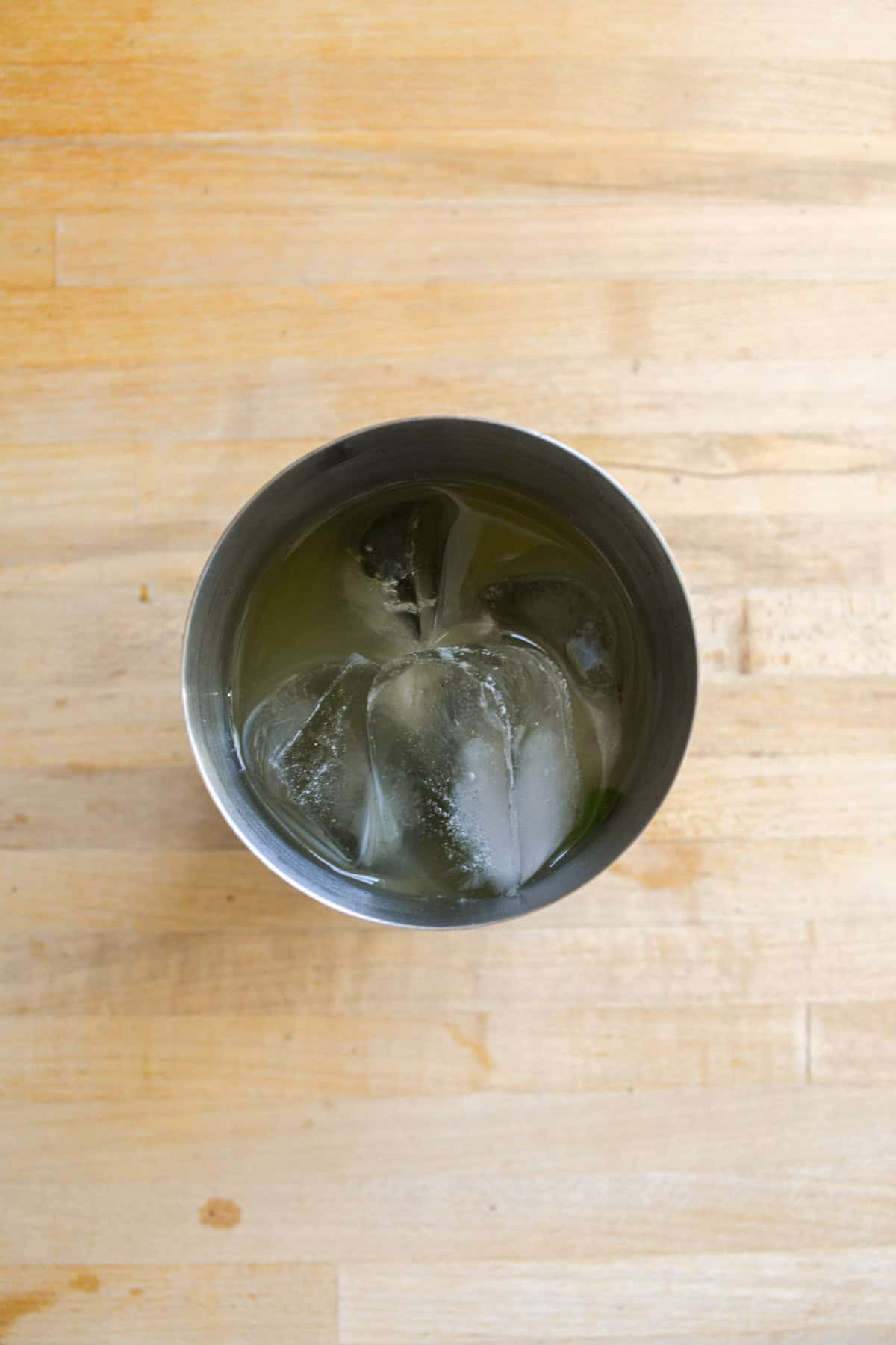 Cocktail shaker filled with liquid and ice.