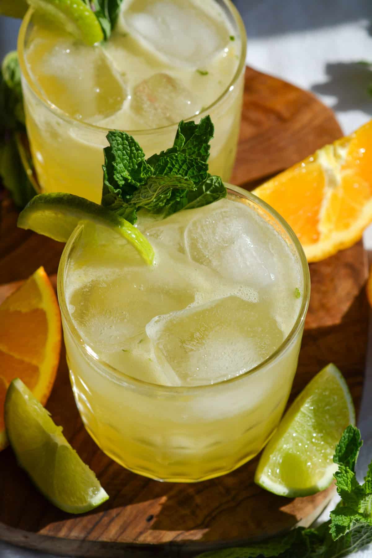 Tequila Smash cocktail in a glass garnished with mint leaves and a lime wedge.