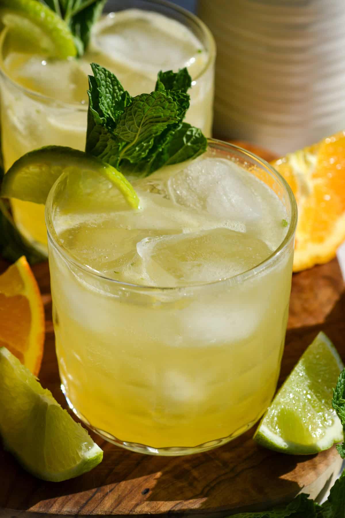 Tequila Smash in a class garnished with mint and a lime wedge.