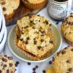 A Vegan Chocolate Chip Muffin cut in half to show the fluffy interior.