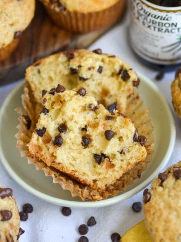 A Vegan Chocolate Chip Muffin cut in half to show the fluffy interior.